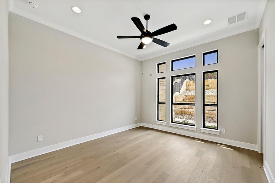 Hardwood floors and a ceiling fan complete this airy, south facing room. There is an en-suite and very large walk-in closet