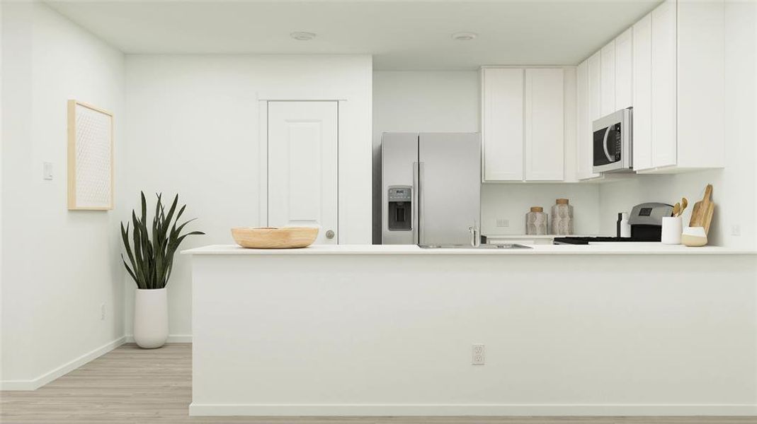 Kitchen featuring a peninsula, stainless steel refrigerator with ice dispenser, white cabinetry, stove, and light wood-type flooring