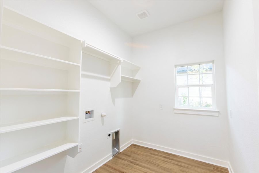 Well-sized utility room perfect for organization and storage.