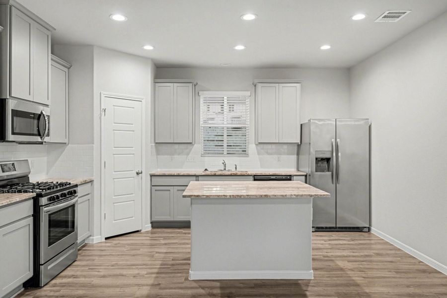 Functional kitchen layout with gas range. Functional kitchen layout with gas range.