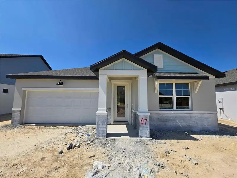 Front exterior of a new home in , Spring Hill, FL, highlighting curb appeal (Image 1).