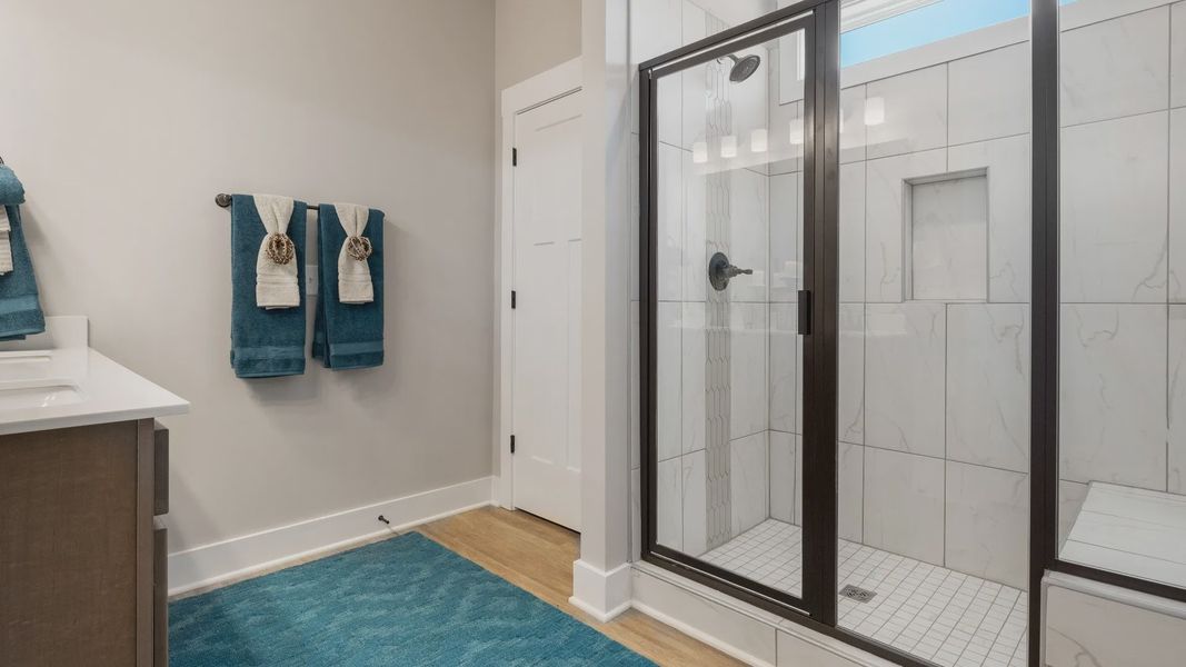 Highly functional and elegant en-suite with dual vanities, tiled walk-in shower, and refined finishes in Woodruff, SC