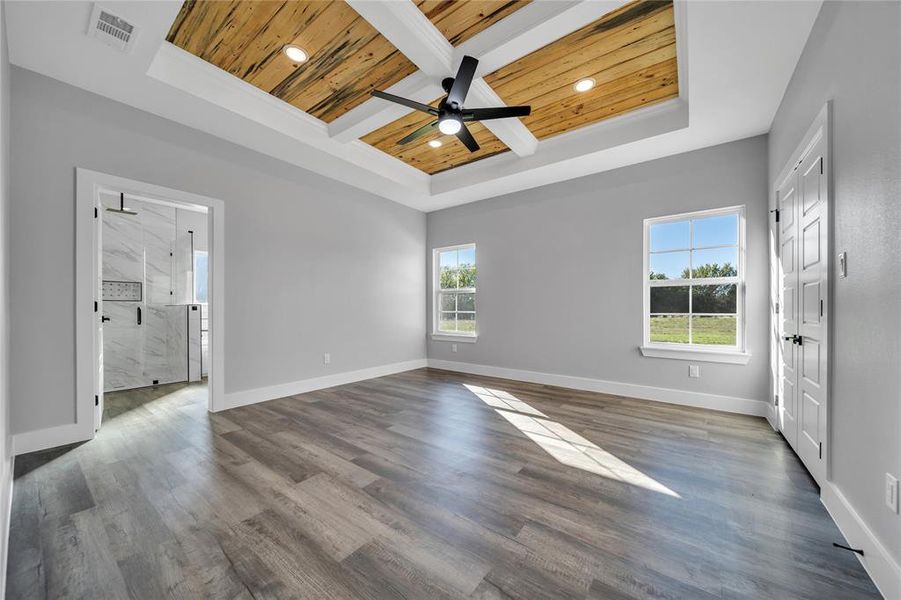 Unfurnished room with hardwood / wood-style flooring, wooden ceiling, and plenty of natural light