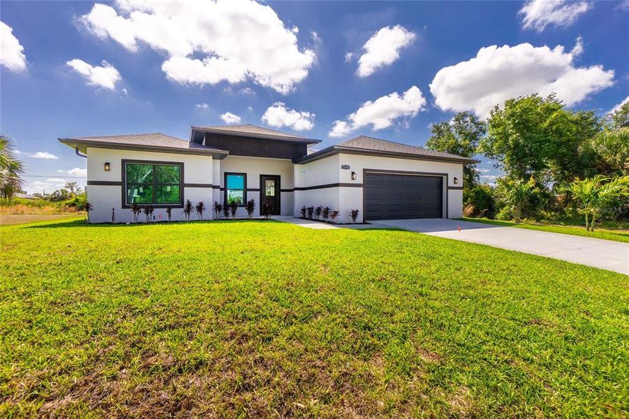 Front exterior of a new home in , Port Charlotte, FL, highlighting curb appeal (Image 25).