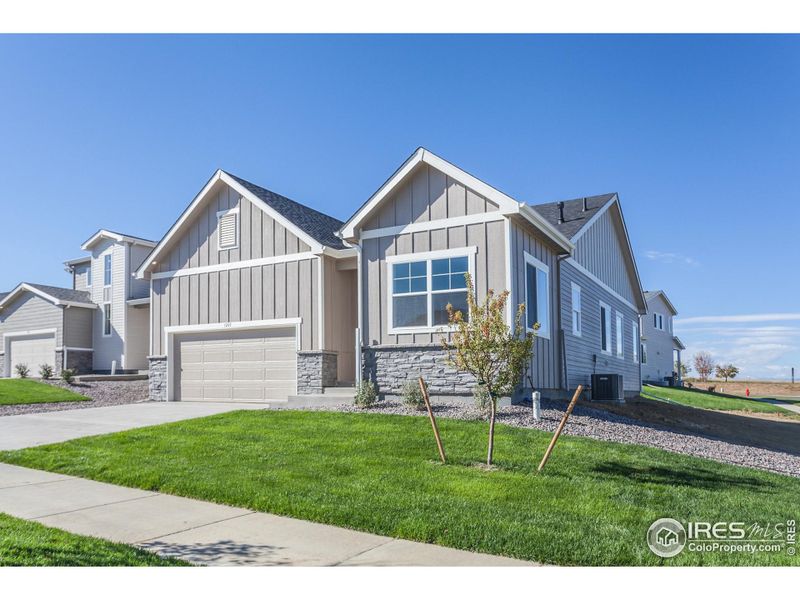 Front exterior of a new home in Promontory Point, Greeley, CO, highlighting curb appeal (Image 25).