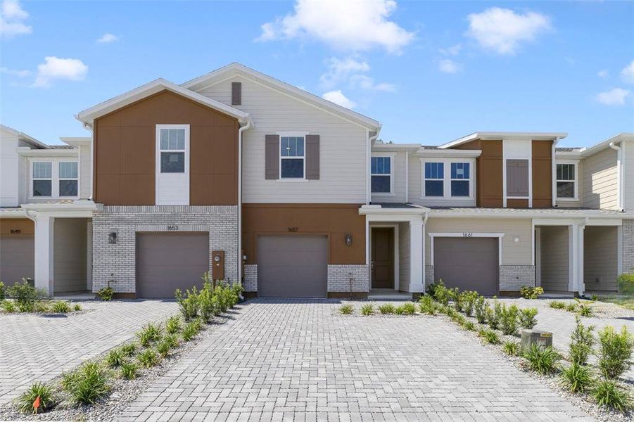 Front exterior of a new home in Towns at Greenleaf, Oviedo, FL, highlighting curb appeal (Image 1). Front exterior of a new home in Towns at Greenleaf, Oviedo, FL, highlighting curb appeal (Image 1).