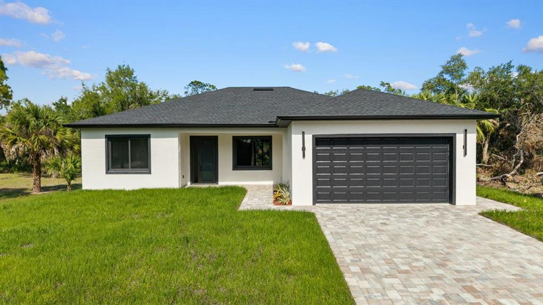 Front exterior of a new home in , Port Charlotte, FL, highlighting curb appeal (Image 2).
