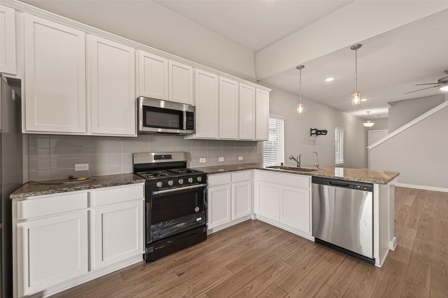 The kitchen features vaulted ceilings, abundant cabinet space, stainless steel appliances, and a functional layout designed for everyday living. The kitchen features vaulted ceilings, abundant cabinet space, stainless steel appliances, and a functional layout designed for everyday living.