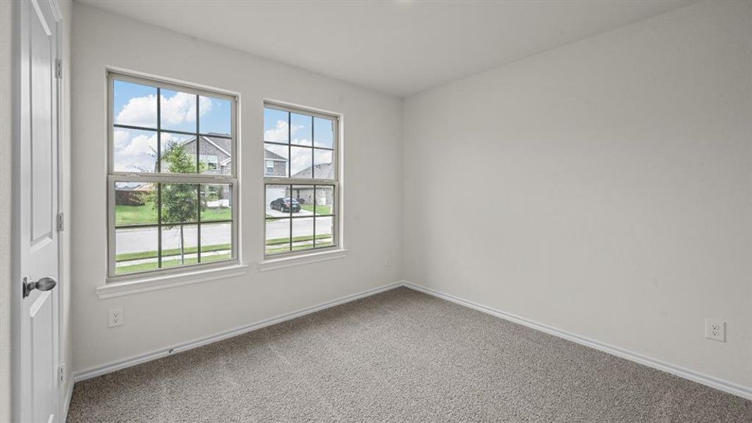 Unfurnished room featuring baseboards and light colored carpet