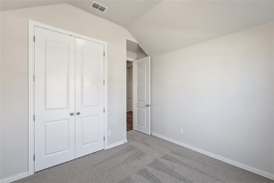 Light gray carpeting with a subtle pattern and white baseboards