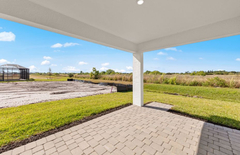 Exterior details and patio area of a home in Whispering Lakes, Lehigh Acres (Image 3).