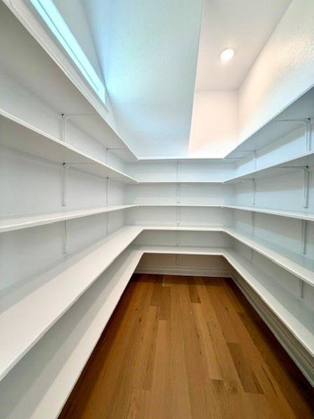 Ample storage solutions abound in this well-appointed pantry, featuring extensive shelving. Ample storage solutions abound in this well-appointed pantry, featuring extensive shelving.