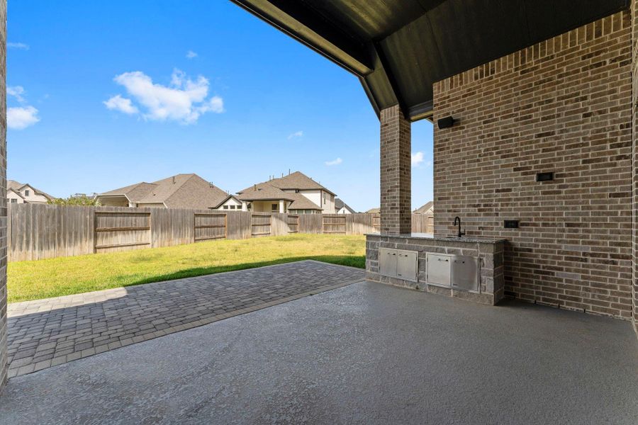 Outdoor living done right with an extended, covered patio, summer kitchen, and all. Outdoor living done right with an extended, covered patio, summer kitchen, and all.