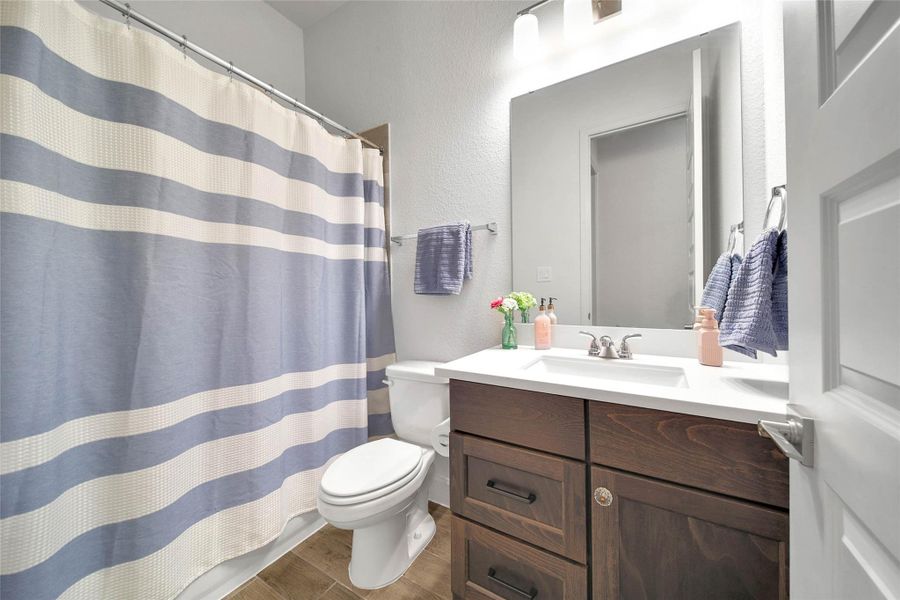 This shared secondary bath is tucked between the bedrooms for privacy and easy access.