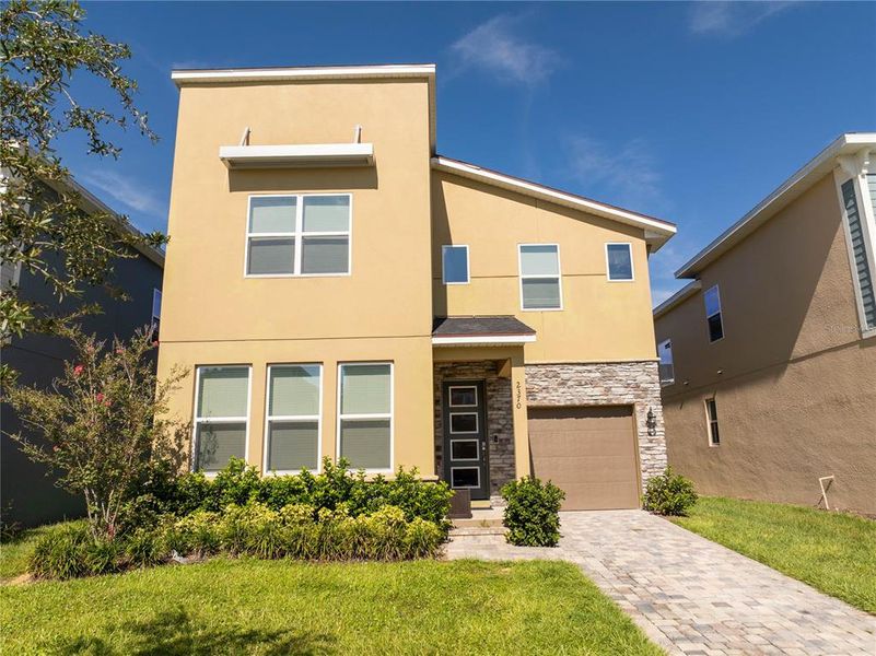 Front exterior of a new home in , Kissimmee, FL, highlighting curb appeal (Image 2).