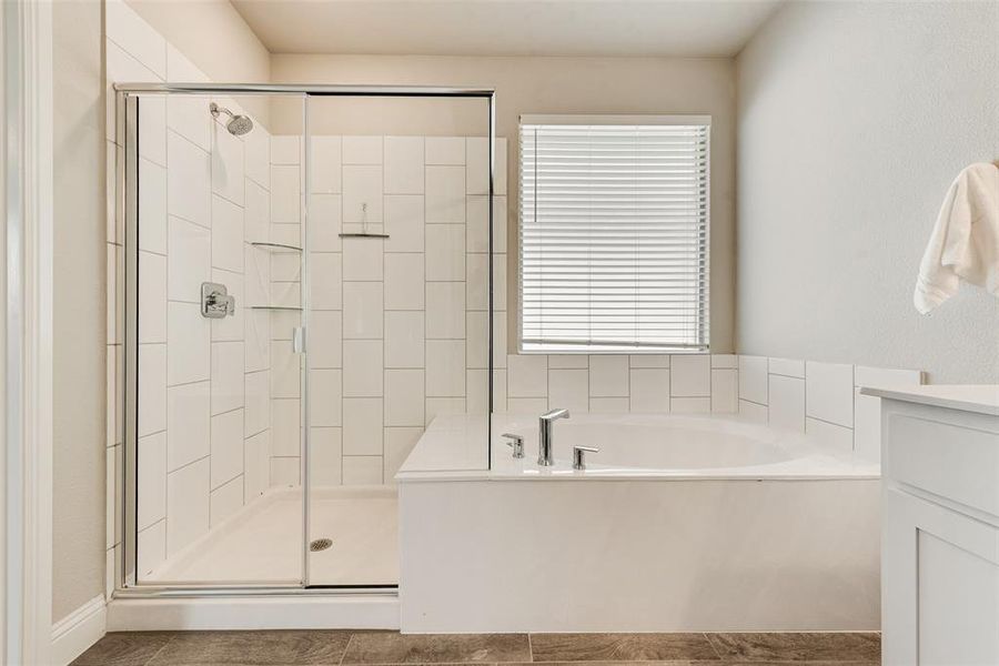 Bathroom featuring a stall shower, a bath, vanity, and tile patterned floors