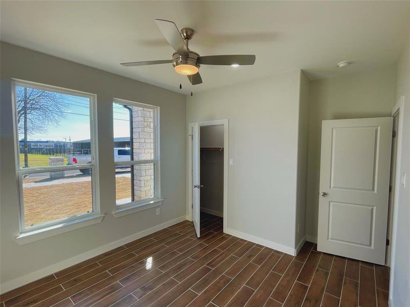 Unfurnished bedroom featuring ceiling fan