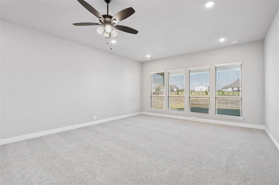 Carpeted empty room with recessed lighting and ceiling fan