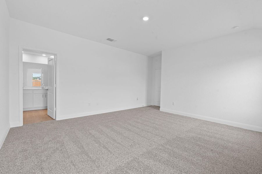 Unfurnished bedroom with light carpet, recessed lighting, and ensuite bathroom Unfurnished bedroom with light carpet, recessed lighting, and ensuite bathroom