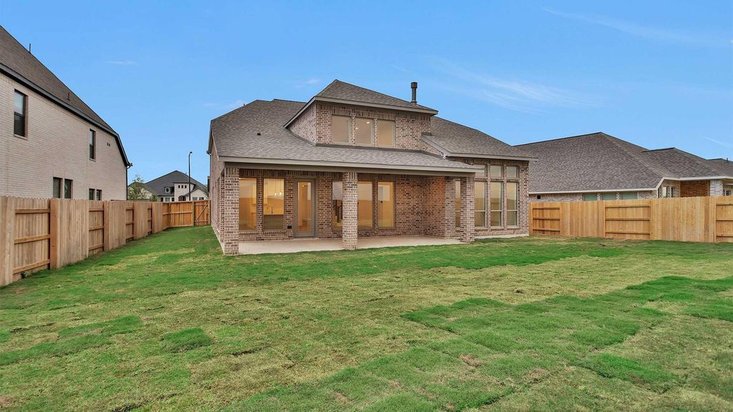 Front exterior of a new home in Elyson 55', Katy, TX, highlighting curb appeal (Image 1). Front exterior of a new home in Elyson 55', Katy, TX, highlighting curb appeal (Image 1).
