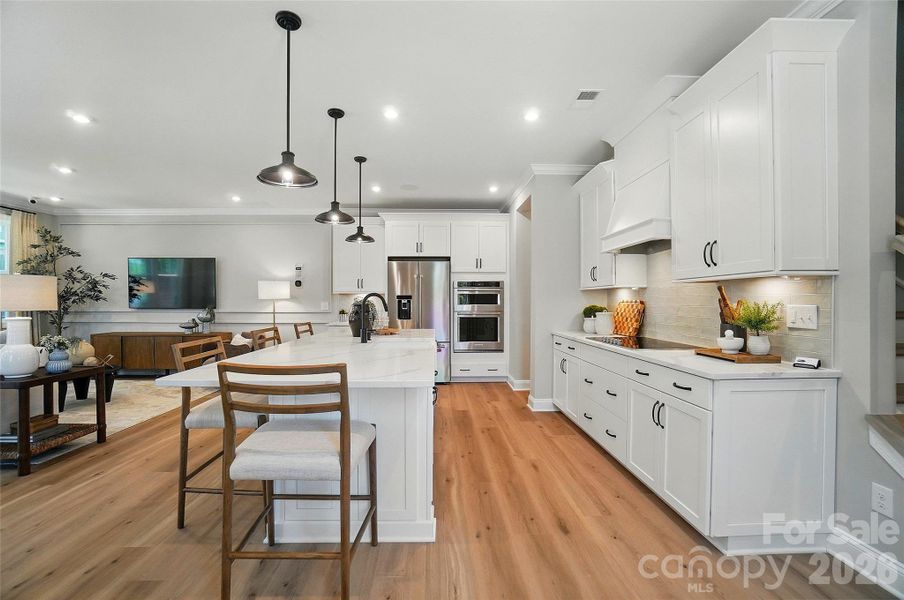 Representation only- this home has same cabinets, flooring, pendants, sink, backsplash and countertops as model home ( pictured )