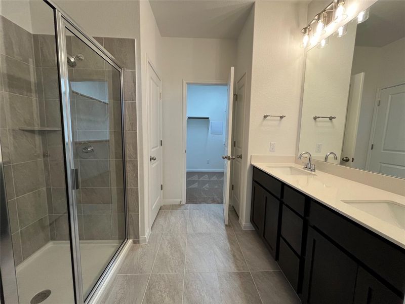 Masterbath with large walk-in shower, double vanity and walkin closet. For demonstration purposes only. This will be the same interior layout. Colors can vary.