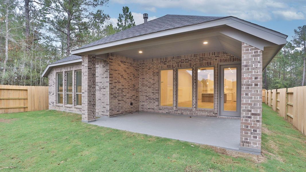 Exterior details and patio area of a home in Woodhavyn 50', Magnolia (Image 2).