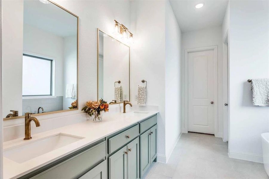 Full bathroom with a soaking tub, double vanity, recessed lighting, and light tile patterned flooring Full bathroom with a soaking tub, double vanity, recessed lighting, and light tile patterned flooring