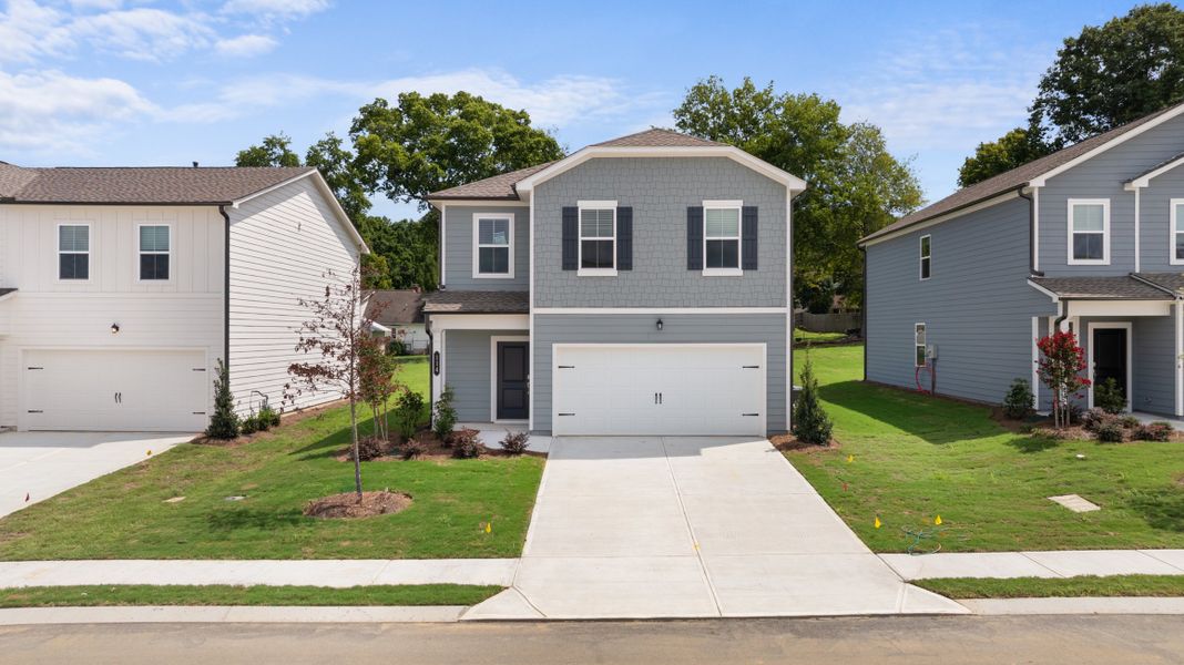 Front exterior of a new home in The Stables, Rossville, GA, highlighting curb appeal (Image 1).