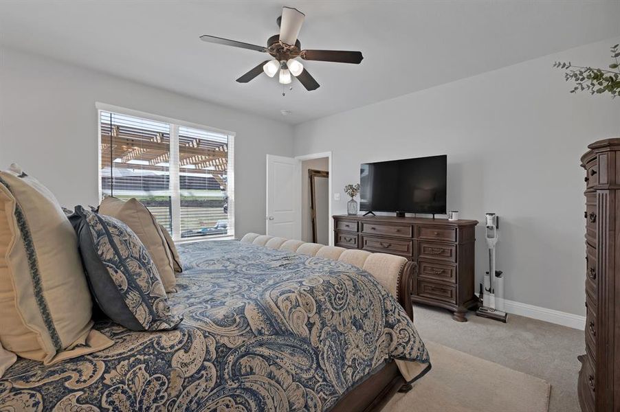 Bedroom with ceiling fan and light colored carpet Bedroom with ceiling fan and light colored carpet