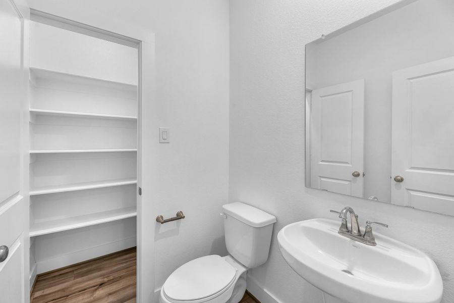 This charming home features a beautifully appointed half bath adjacent to the family room, perfect for welcoming guests and adding convenience to your daily life.