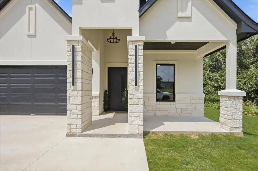 A modern exterior facade with stone accents and a welcoming entry. A modern exterior facade with stone accents and a welcoming entry.