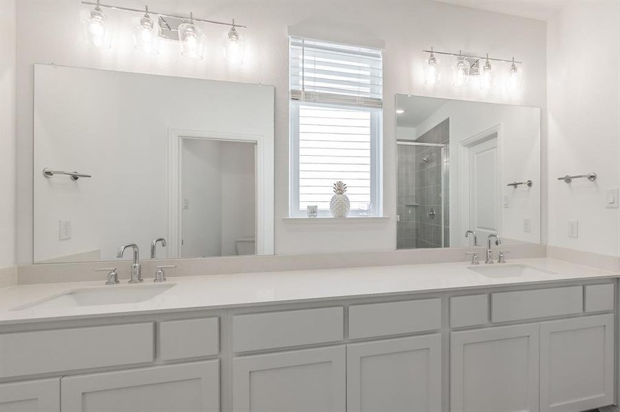 Bathroom with a stall shower and double vanity