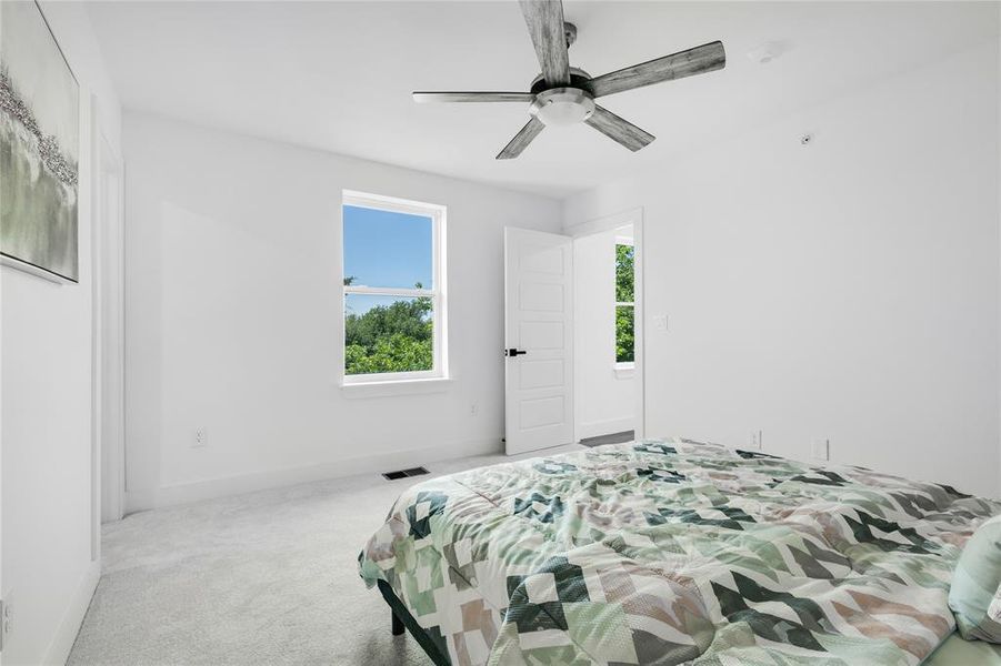 Bedroom with ceiling fan and carpet flooring