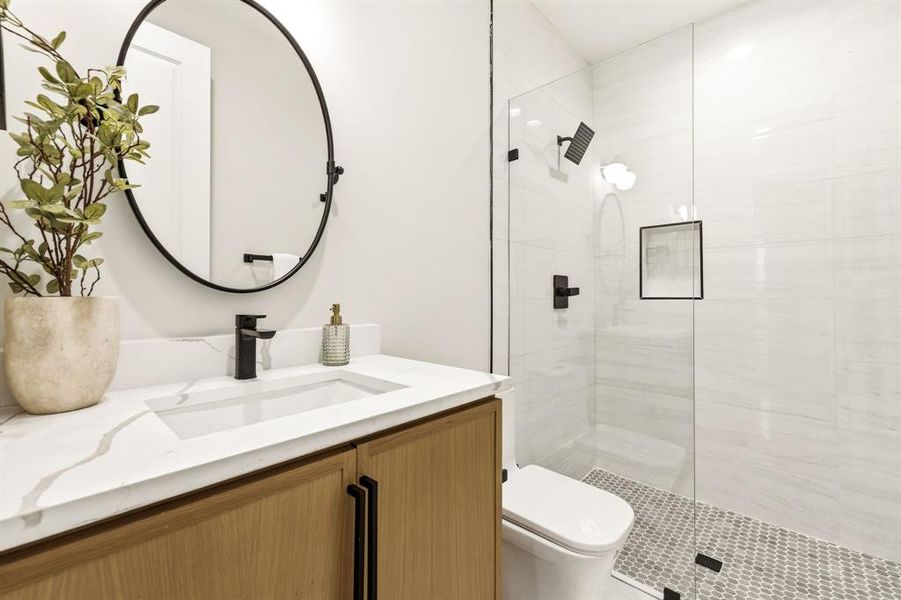 Bathroom featuring vanity and tiled shower