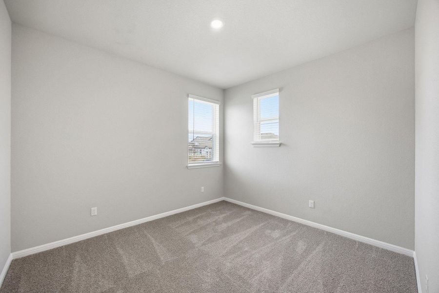 Carpeted empty room with baseboards