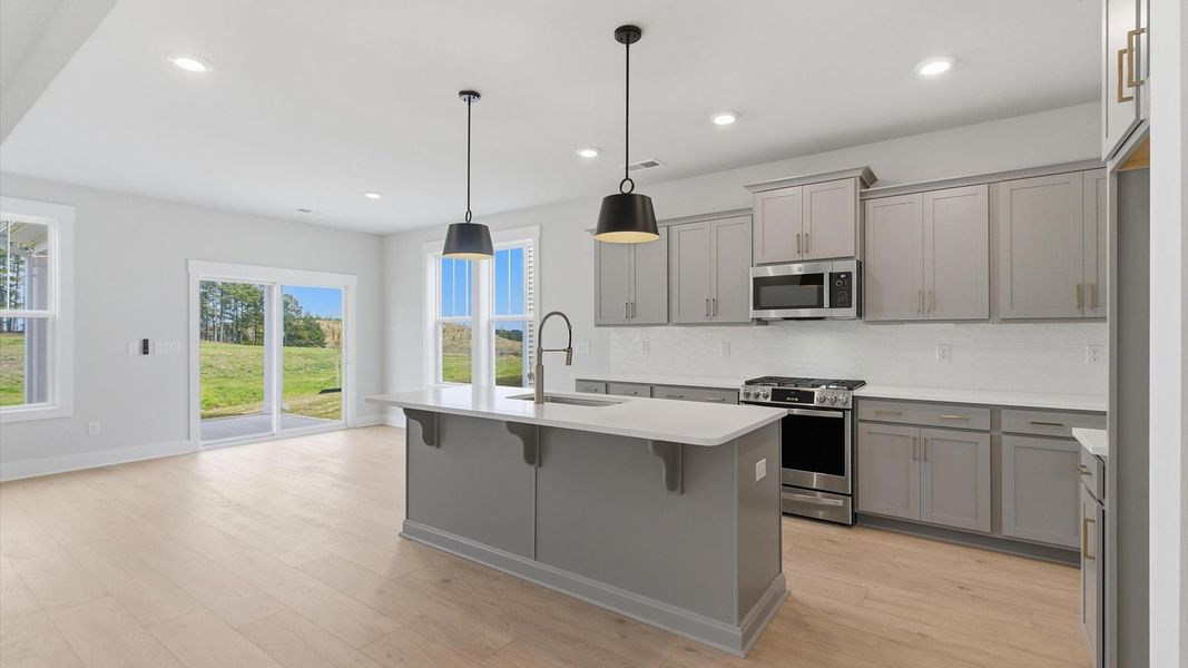 Exceptional kitchen featuring a spacious island, eye-catching pendant lights, and modern finishes located in Gray Court, SC