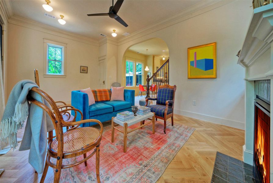 Warm, inviting living space features rich hardwood flooring and a cozy fireplace.