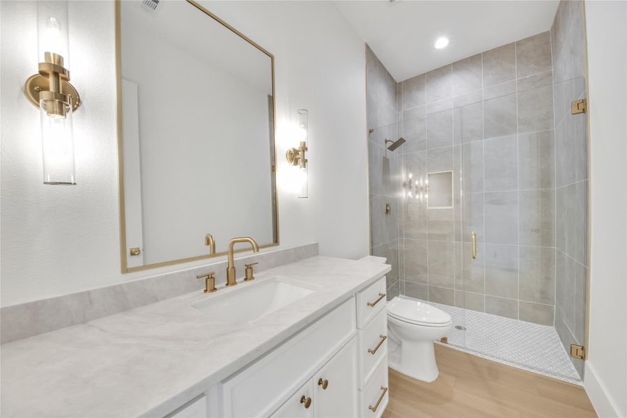 Beautifully designed secondary bathroom featuring a custom vanity, quartz countertops, walk-in shower, modern fixtures, and tile from floor to ceiling. Beautifully designed secondary bathroom featuring a custom vanity, quartz countertops, walk-in shower, modern fixtures, and tile from floor to ceiling.