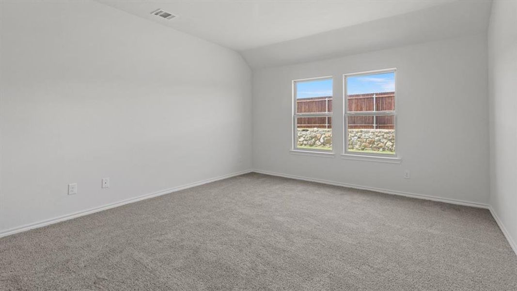 Spacious room featuring neutral carpeting and white wall finishes