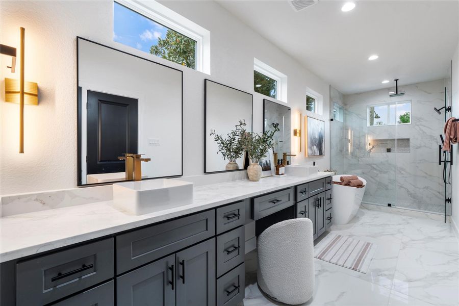 Spa-inspired bath with dual vanities, quartz counters, and porcelain tile throughout. Even room for a makeup vanity! Spa-inspired bath with dual vanities, quartz counters, and porcelain tile throughout. Even room for a makeup vanity!