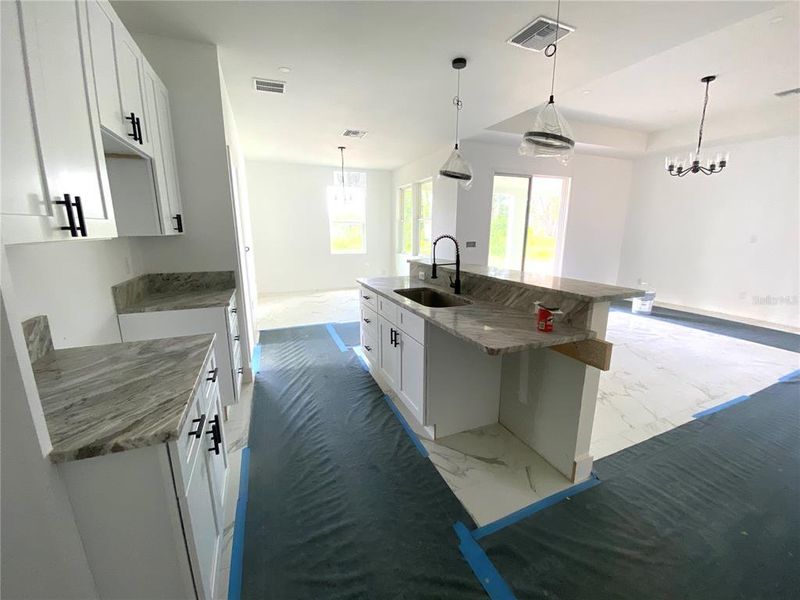 kitchen bar/island with farm house style sink, dishwasher