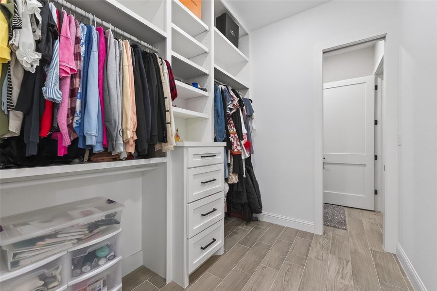 Custom walk-in closet with built-in shelving and drawer storage. Custom walk-in closet with built-in shelving and drawer storage.