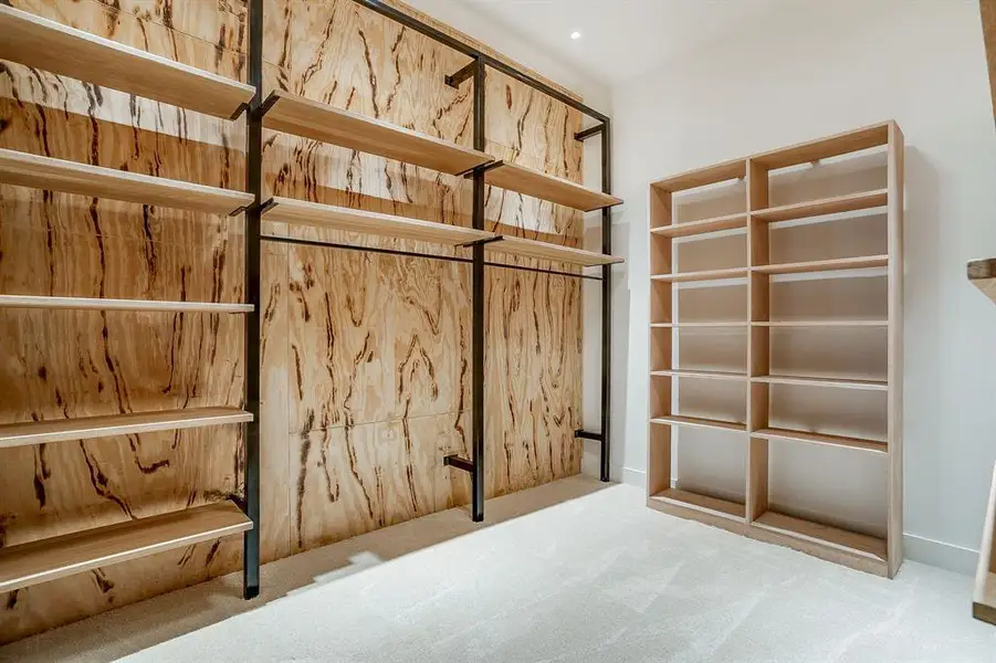 Spacious closet featuring carpet flooring Spacious closet featuring carpet flooring