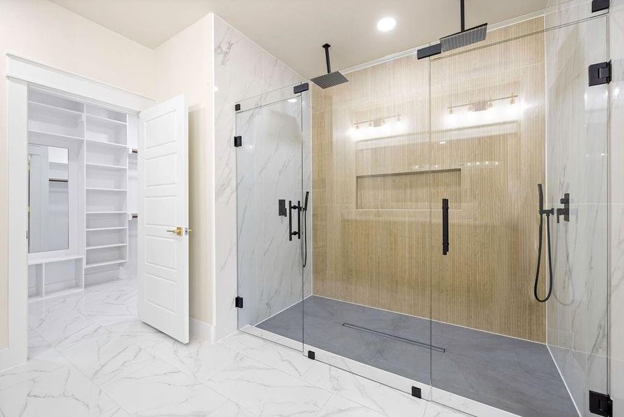 Full bathroom with marble finish floor, a spacious closet, a marble finish shower, and recessed lighting