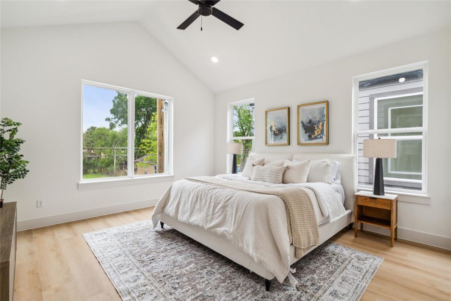 Wake up to vaulted ceilings and walls of natural light in a primary suite designed for comfort, calm, and quiet luxury.