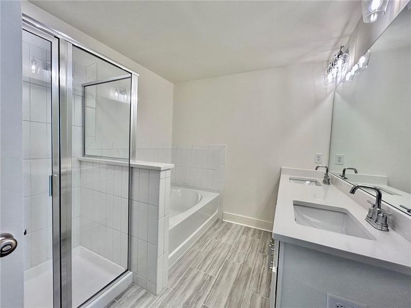 Bathroom with tile floors, plus walk in shower, and dual vanity