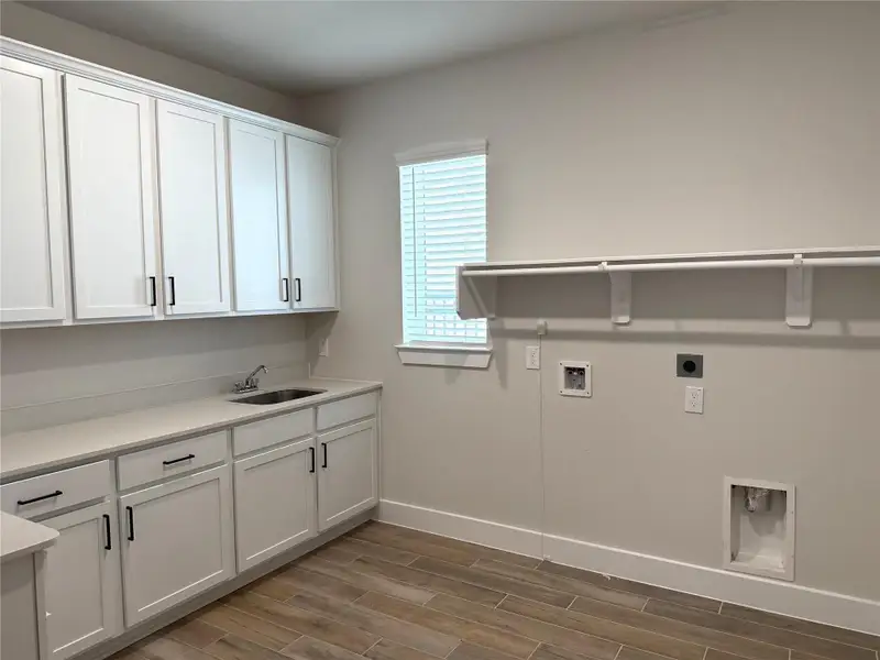 Laundry day just got better with an extended space, sink, cabinetry & abundant storage!