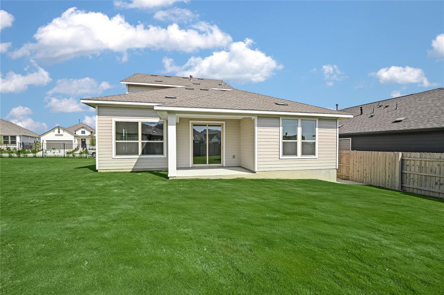 Back of house featuring a patio area, a fenced backyard, and a shingled roof