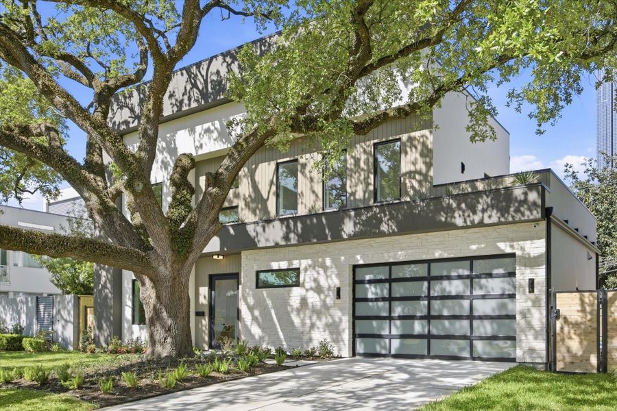 Clean lines and curated materials define the exterior, where contemporary design is softened by organic textures and lush surroundings.